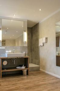 a bathroom with a sink and a mirror at Hotel zur Sonne in Rimsting