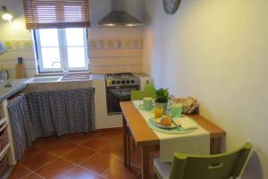 una cucina con tavolo e piatto di cibo di Casa do Largo ad Alcácer do Sal Altre 18 foto