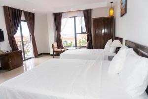 Postel nebo postele na pokoji v ubytování Aries Hotel
