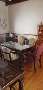 a dining room table with two chairs and a table at Uniondale Guest Lodge in Uniondale