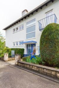 a woman sitting in front of a house at Apartment with a view - Daheim am Wasserturm in Wörth am Rhein