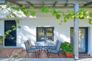 a patio with chairs and a table on a porch at Scandia Villas in Potos