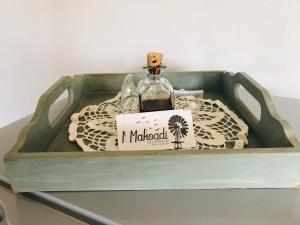 a bottle of alcohol sitting in a wooden box at Makoadi Farms Guesthouse in Clocolan +24 photos