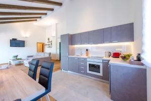 a kitchen with a table and a dining room at Villa Nespola Penthouse in Cavtat