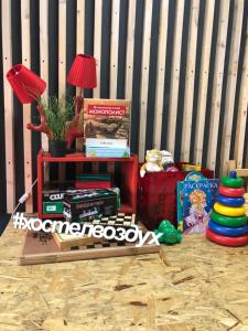 a room with a table with books and a lamp at Vozduh MiniHotel in Vladimir