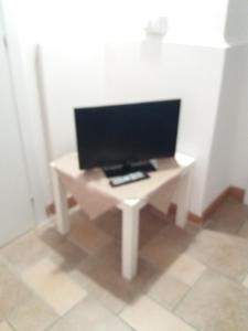 a white desk with a tv on top of it at Hotel Blu in Rieti