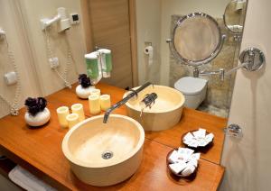 a bathroom with two sinks on a wooden counter at Hotel Capitolina City Chic in Cluj-Napoca +61 photos