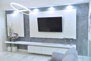 a living room with a tv on a wall at N&L in Banja Luka