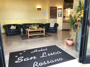 a waiting room with a hotel san lorenzorano sign at Hotel San Luca in Rossano