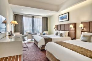 Uma cama ou camas num quarto em The George, Urban Boutique Hotel