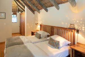 Postel nebo postele na pokoji v ubytování Coral Tree Cottages