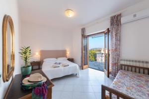 a hotel room with a bed and a balcony at Hotel Europa in Ischia