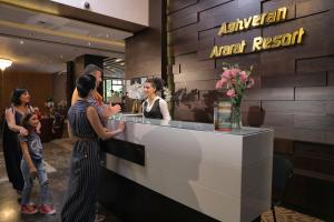 a group of people standing around a counter in a restaurant at Aghveran Ararat Resort Hotel in Arzakan