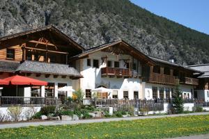 a large building with a mountain in the background at Alpenrast Tyrol in Mils bei Imst