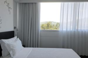 Cama ou camas em um quarto em Open Village Sports Hotel & Spa Club