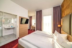 Postel nebo postele na pokoji v ubytování Hotel am Stadtrand