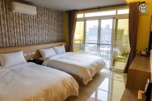 מיטה או מיטות בחדר ב-金門樂客民宿