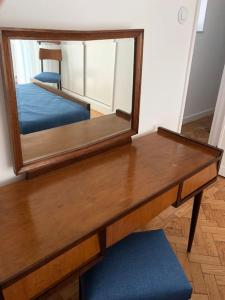 a mirror sitting on top of a wooden table at SEA RIA - A casa dos Maria in Costa Nova +7 photos
