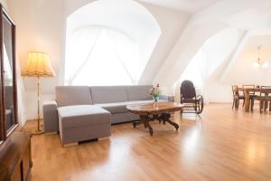 a living room with a couch and a table at Jacob Brno Apartments in Brno