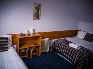 מיטה או מיטות בחדר ב-The Dingle Pub Rooms