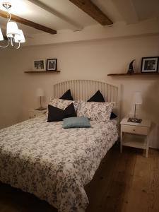 a bedroom with a bed and two tables with lamps at Space Nr. 11 in Merano