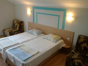 a hotel room with a bed and a chair at Guest rooms Rusalka in Kranevo +66 photos