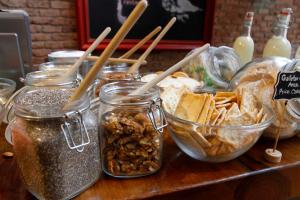 a table topped with jars of food and snacks at NOI Vitacura in Santiago