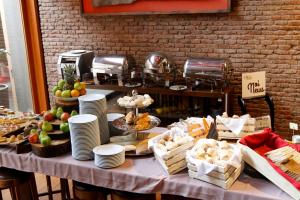 a table with a buffet of food on it at NOI Vitacura in Santiago
