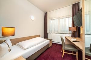 Postel nebo postele na pokoji v ubytování Hotel am Stadtrand