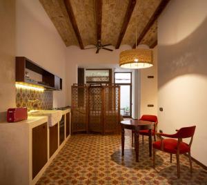 a kitchen with a table and chairs and a dining room at Natural loft in Valencia