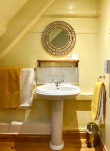 a bathroom with a sink and a mirror at Cyntwell Guest Accommodation in Padstow