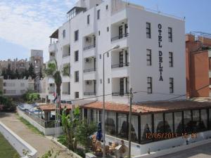 a large white building with a sign on it at Delta Hotel in Didim