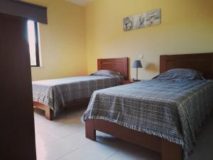 a hotel room with two beds and a window at Jardins da Falesia in Albufeira