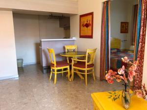 a dining room with a table and two chairs at Hotel La Galleria in Le Lamentin