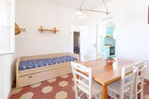 a bedroom with a bed and a table and chairs at Villa Emilia in Marina di Castagneto Carducci
