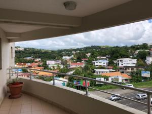 a balcony with a view of a city at Hotel La Galleria in Le Lamentin