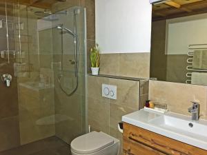 a bathroom with a shower and a toilet and a sink at Alkira in Sankt Anton am Arlberg
