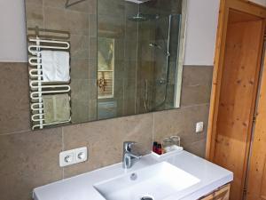 a bathroom with a sink and a mirror at Alkira in Sankt Anton am Arlberg