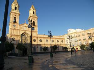 a large building with a clock tower and a church at Loft del Arte in Cádiz
