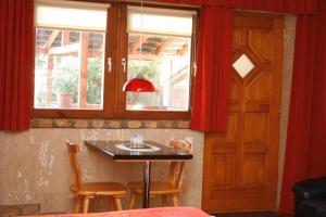 a room with a table with two chairs and a window at Vendégház 60 in Hatvan