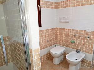 a bathroom with a toilet and a sink at villette acquamarina Budoni in Budoni +23 photos