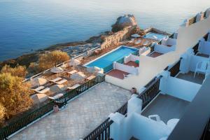 an aerial view of a villa with a swimming pool at Cavos Bay Hotel & Studios in Armenistis