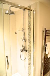 a shower with a glass door in a bathroom at The Barn, Higher Boden, Manaccan, Helston, Cornwall in Helston