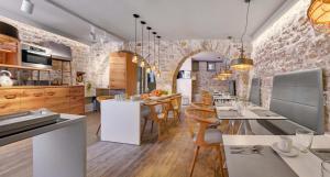 a kitchen with a table and chairs in a room at Hotel Boulgari in Ioannina