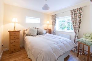 a bedroom with a bed and a window at Prince Hill Cottages in Worton