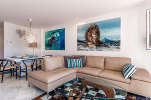 a living room with a couch and a table at El Dorado by Puerto Banus in Marbella