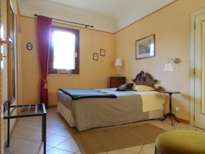 a bedroom with a bed and a window at Cappone B&B in Morciano di Romagna