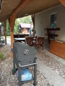 a stove in a patio with a table and chairs at Borókahaus in Tata