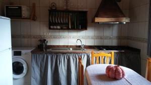a kitchen with a sink and a table with a tablecloth at Casa Fátima Valle Gran Rey in Valle Gran Rey