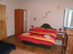 A bed or beds in a room at Viola Vendégház